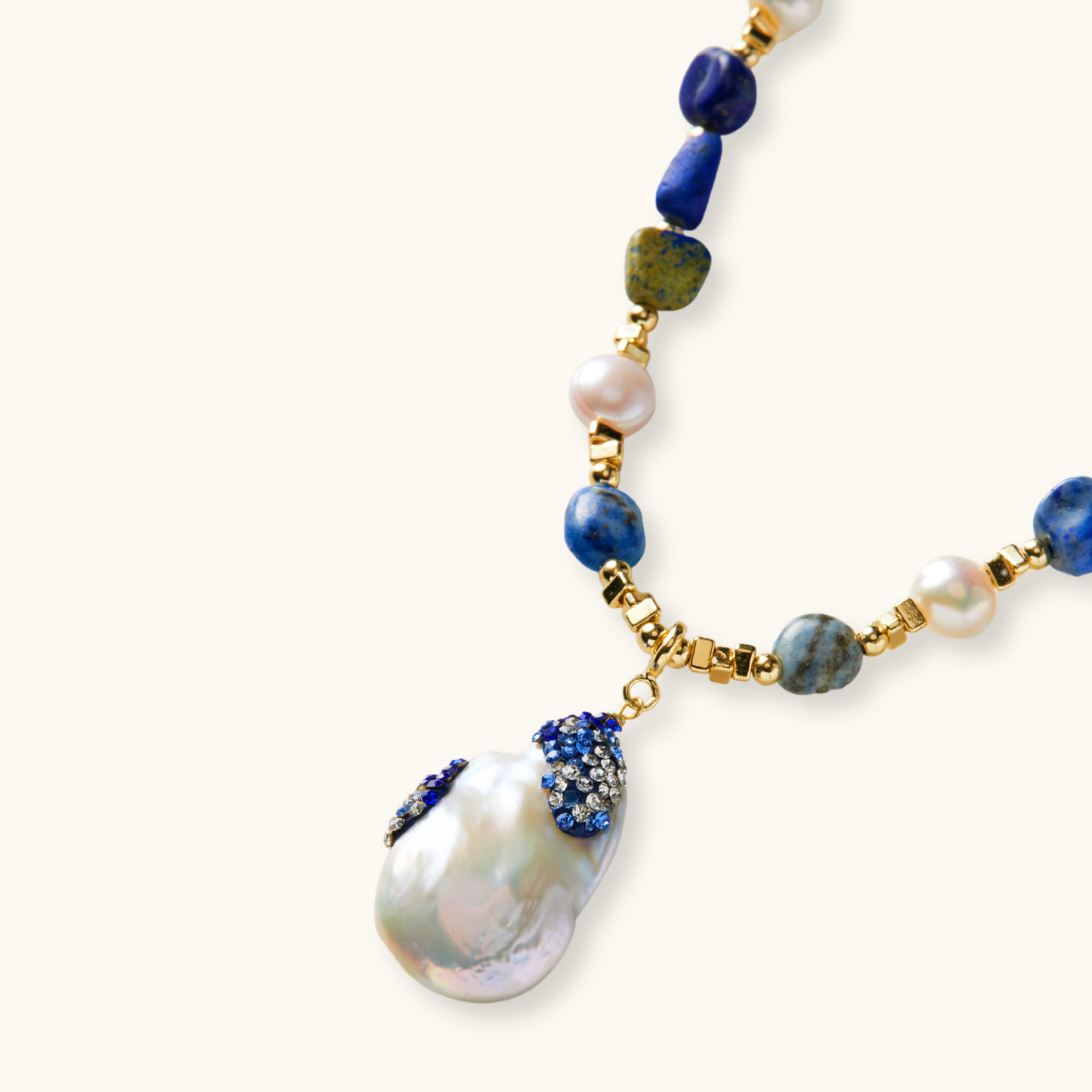 Handcrafted necklace with lapis lazuli and Baroque pearl with gradient blue and white zirconia accents