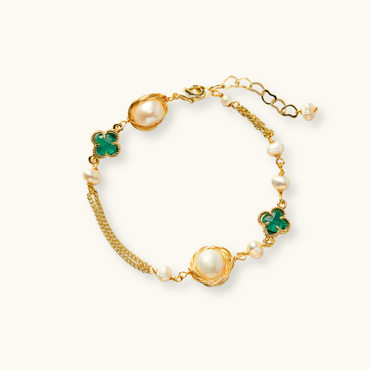 Handcrafted bracelet with gold-wrapped champagne freshwater pearls and four-leaf clover green zirconia accents on a 14k gold-plated chain